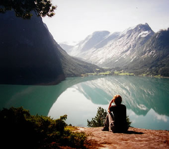 Boy sitting by a lake