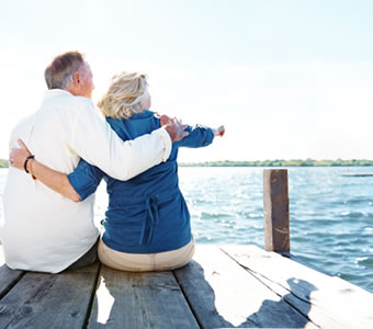 Retired couple sitting on a boat dock